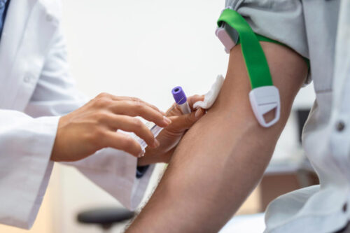 preparation-blood-test-by-female-doctor-medical-uniform-table-white-bright-room-nurse-pierces-patient-s-arm-vein-with-needle-blank-tube